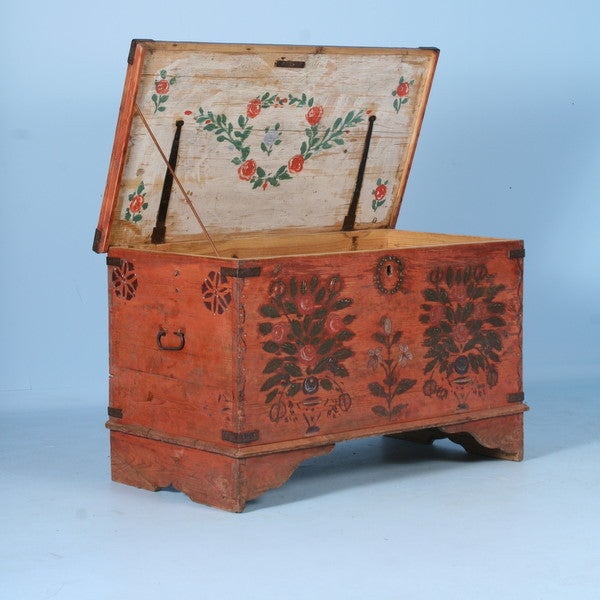 This hand painted pine trunk still maintains its original beautifully worn paint and flower motif. When opened, even the interior top of the trunk top has a lovely floral design as well, creating visual intrigue and a 'surprise