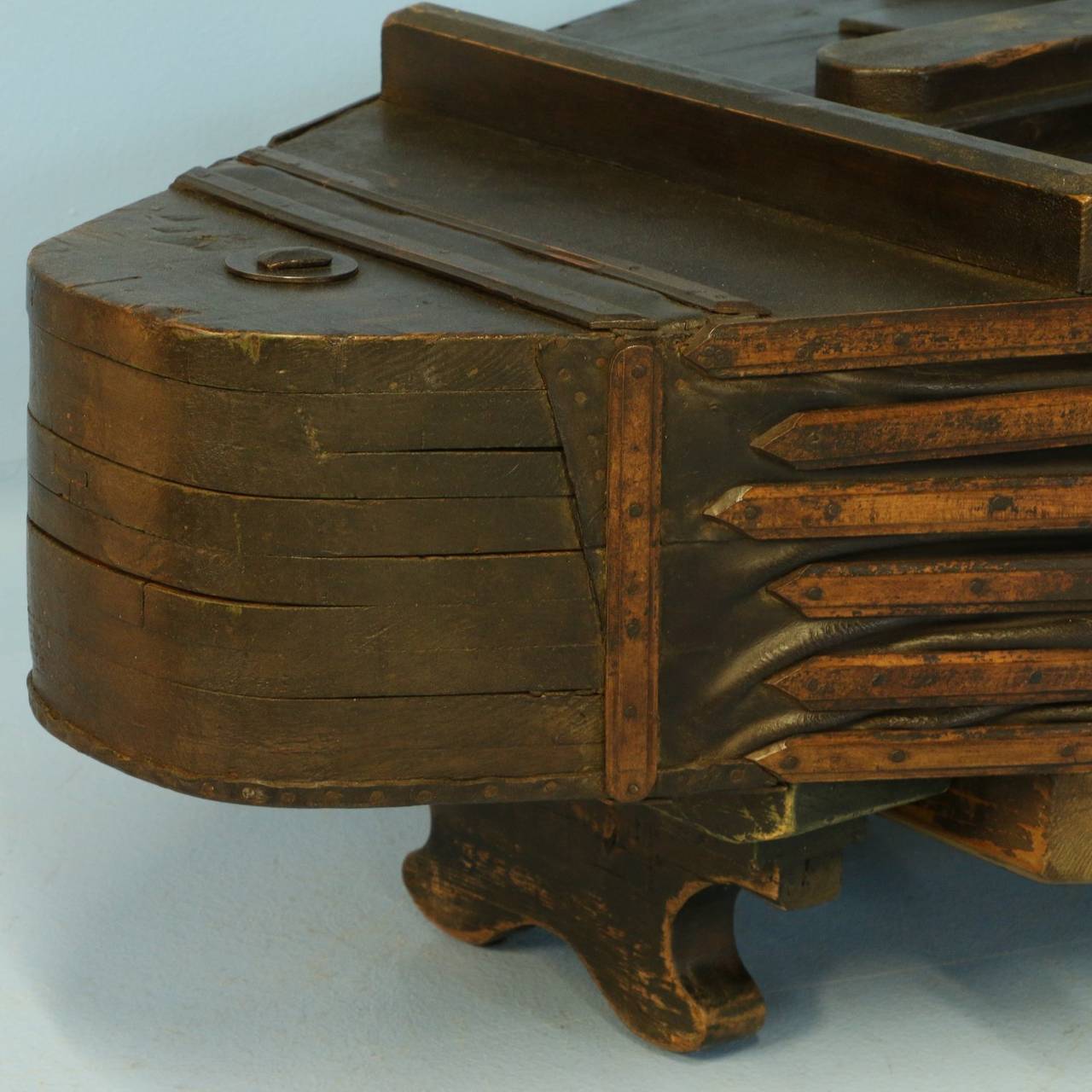 This coffee table is made from an original, large blacksmith bellows which was used throughout the 1800's. It has great charisma, with the conditioned leather, wrought iron details and the painted dark patina of the wood. The base was added to
