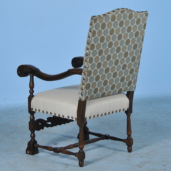 It is the new, contemporary upholstery of geometric circular patterns against the back and clean linen on the seat that creates a fresh, modern look while maintaining this chair's vintage roots. The arm chair reveals its traditional Danish baroque