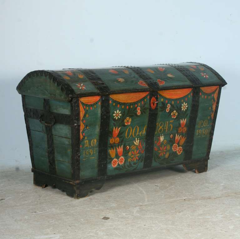 The original painting is exceptional on this highly decorated Swedish trunk. There are 3 sets of monograms and dates, the largest central one of 1843. This was likely a wedding or anniversary present for a couple.Lovely, colorful tulips and other