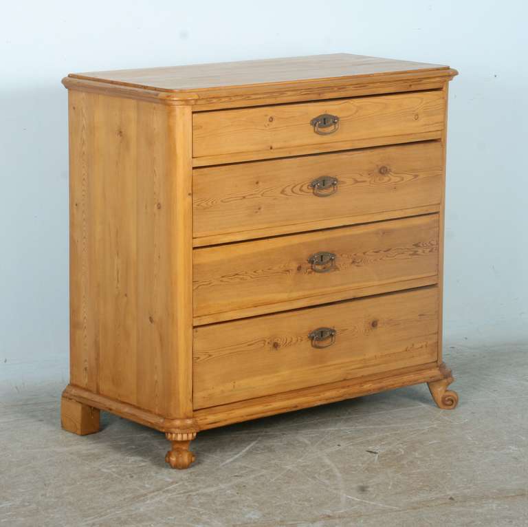 The simple, clean lines of this pine chest of drawers are true to its Scandinavian roots. The carved  feet in front add a touch of visual appeal and are original to the dresser. It has been professionally restored, drawers run smooth and it is ready