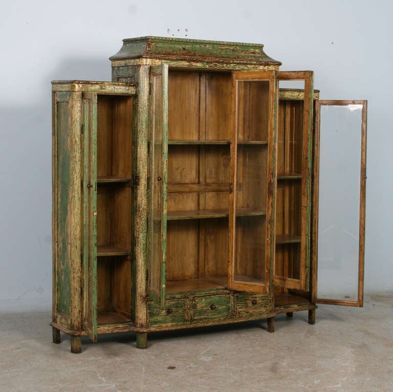 This remarkable bookcase still maintains its original paint, distressed over years of use and protected with a lacquer finish. Whether used for books or to display a special collection, this cabinet is stunning on its own.