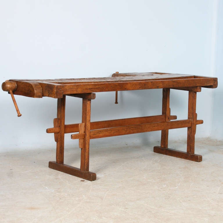 This rustic carpenter's workbench has 2 vices which add to the intriguing look and character of the piece. Workbenches such as this are often used as sofa tables or kitchen islands in modern homes today.