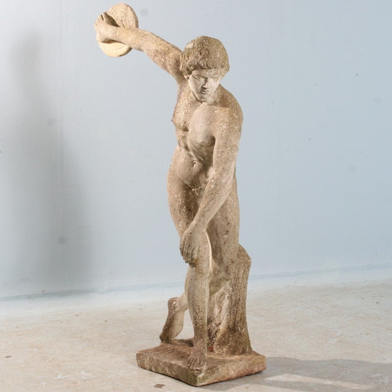 Large Scale Antique  Garden Sculpture. This large piece has been sitting outside for 100 years, creating a beautiful, worn patina including the green tint of lichen and moss. Stunning garden piece crafted in the Greek style of a discus thrower.Base