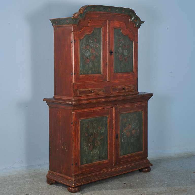 This Original Painted Swedish Cupboard is dated 1796 inside with a monogram of K.L.D. Superb paint and floral details on panels and bonnet. Notice the soft coloring as the patina aged over the years. The slotted shelf inside was to store/display