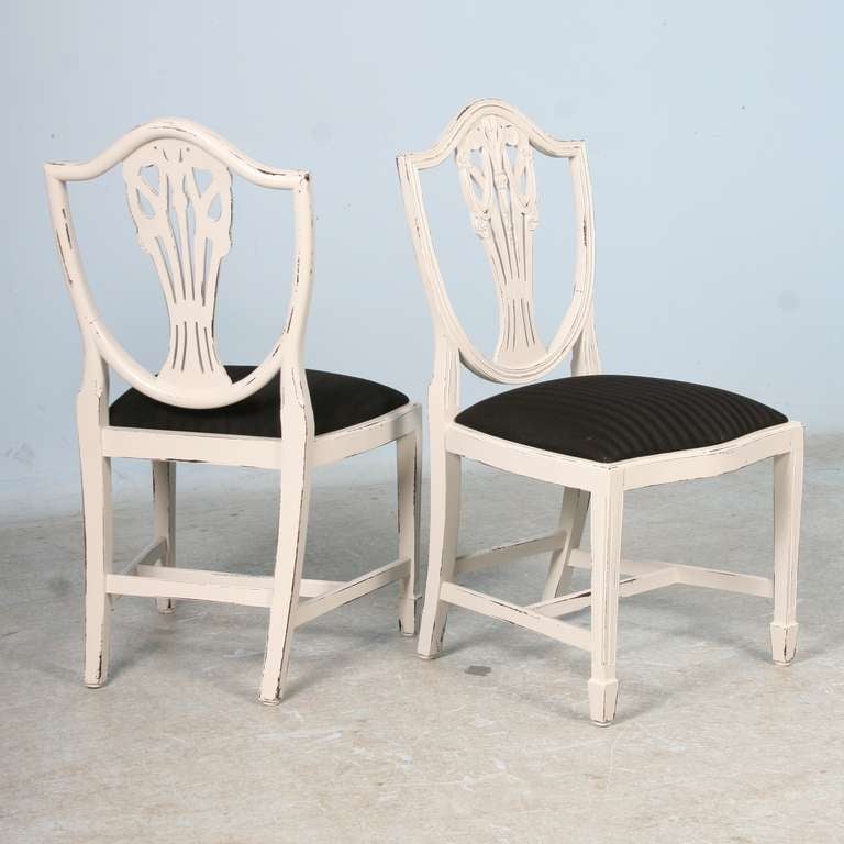 This wonderful set of 8 Swedish chairs is in excellent condition. They have just been given an amazing white painted/distressed finish in the Gustavian style. Please review the close up photos to examine the superb finish. The seats have their
