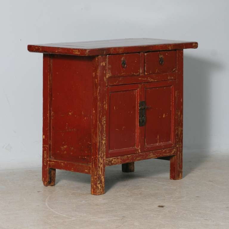 This Chinese sideboard features two top drawers for storage and front opening doors with shelving.The superb quality of this piece is largely due to the exceptional finish. In person, one sees the remarkable richness of the original red color
