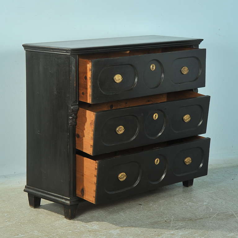 This large pine chest of 3 drawers has recently been given a black painted finish, creating a new look to the old piece. The large drawers are expansive, providing great storage. The round/carved panel motif provides interesting visual impact as