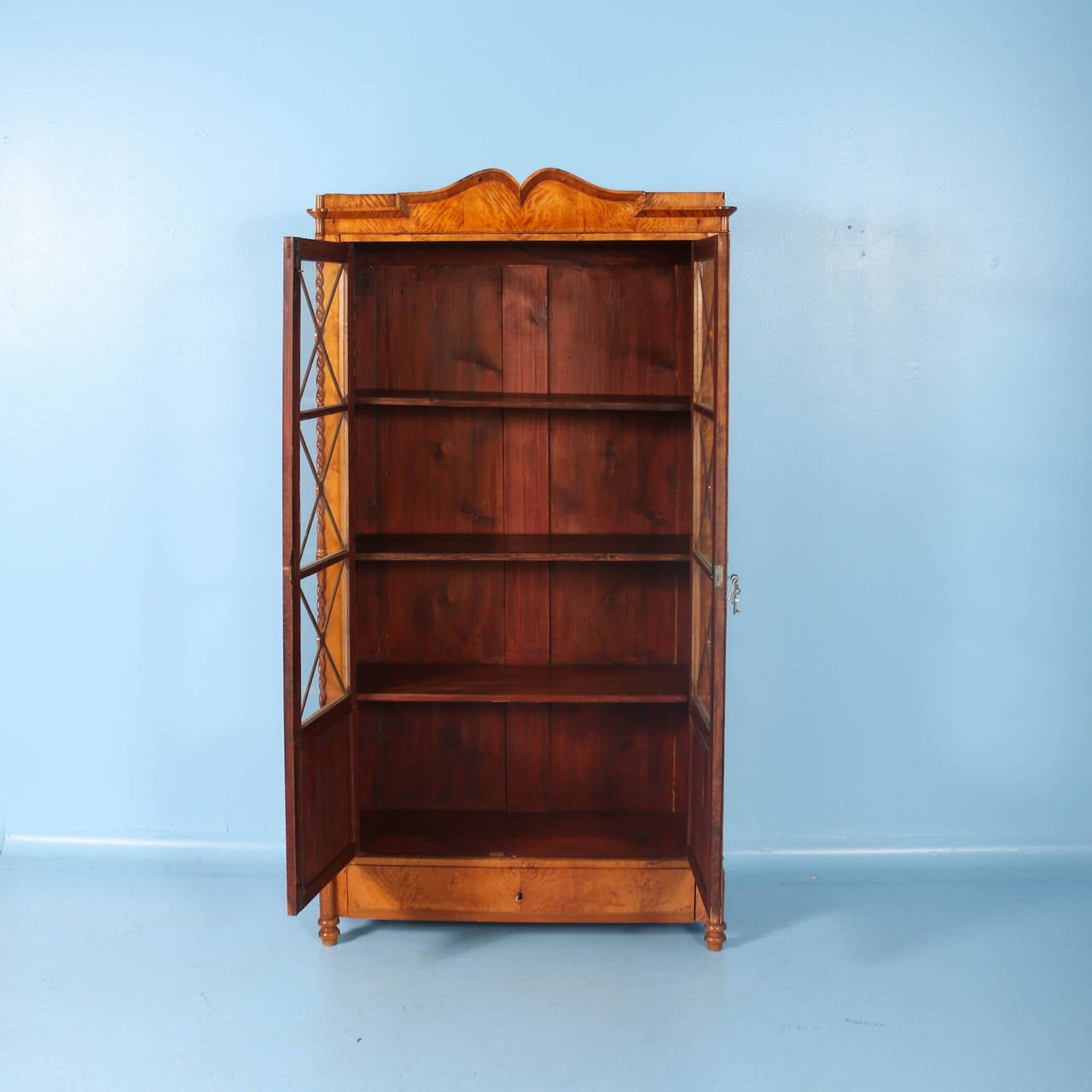 Flaming birch, two-door original Biedermeier bookcase (also know as Karl Johan), from 1830-1850. Please examine the close up photos to appreciate the twisted columns and 