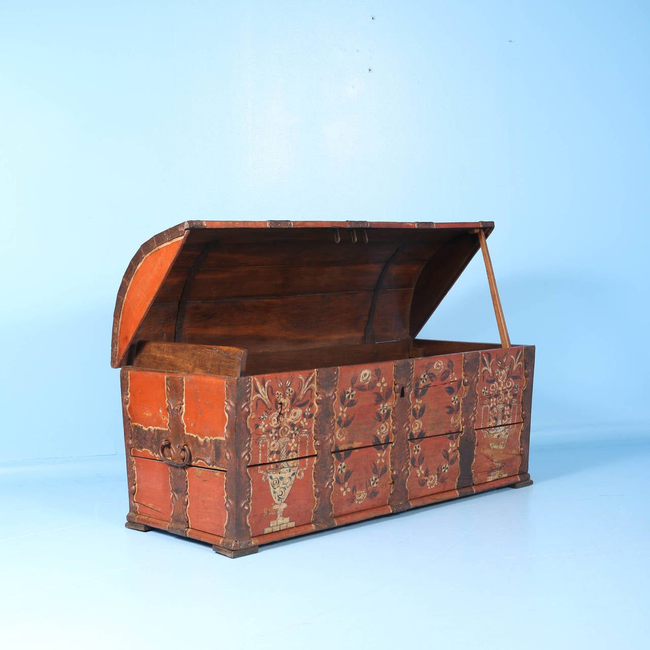 This stunning trunk still maintains its original paint, beautiful colors (red with orange undertone) and florals typical of Swedish folk paint style of the 1800s. The hand-wrought iron banding and handles are also impressive. Entire trunk is very