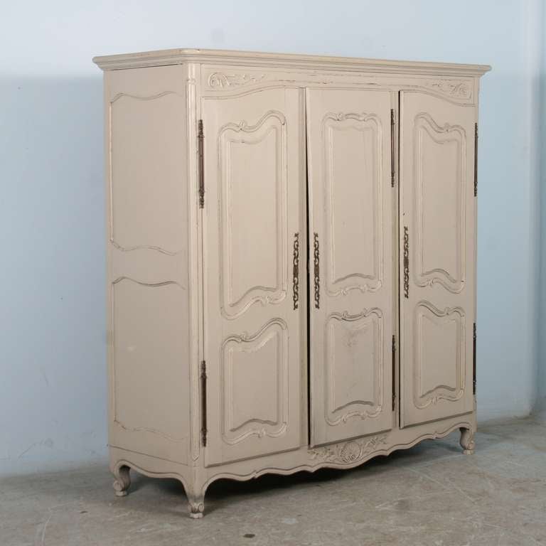This lovely French armoire has been given new life with a recent painted gray/white finish.