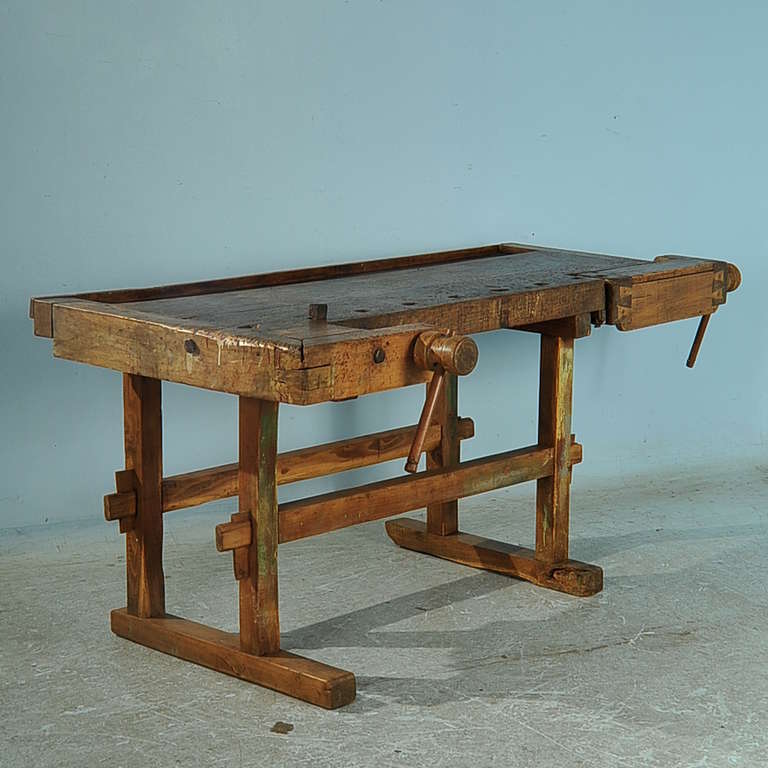 The wonderful, aged patina on this workbench comes from the years of constant use. Notice in the close up photos all the marks in the heavily used top, and even remains of green paint on the legs. The removable metal 