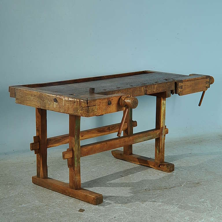 The wonderful, aged patina on this workbench comes from the years of constant use. Notice in the close up photos all the marks in the heavily used top, and even remains of green paint on the legs. The removable metal 