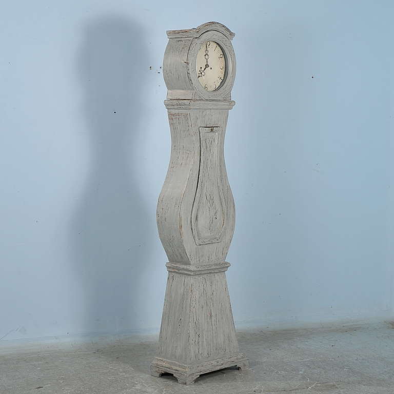 Lovely curves define this grandfather clock from the famous region of Mora, Sweden. It has recently been given a Gustavian grey painted finish, accentuating the Swedish style and adding to the charisma of the clock. The original clockworks may be