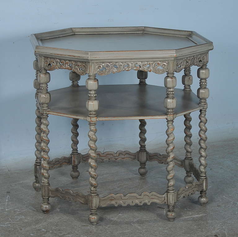 This fascinating table draws the eye due to the unique octagon shape. The barley twist legs, carved skirt and decorative details all combine for an enticing effect, with strong visual impact for a table of its size. The lower shelf adds functional