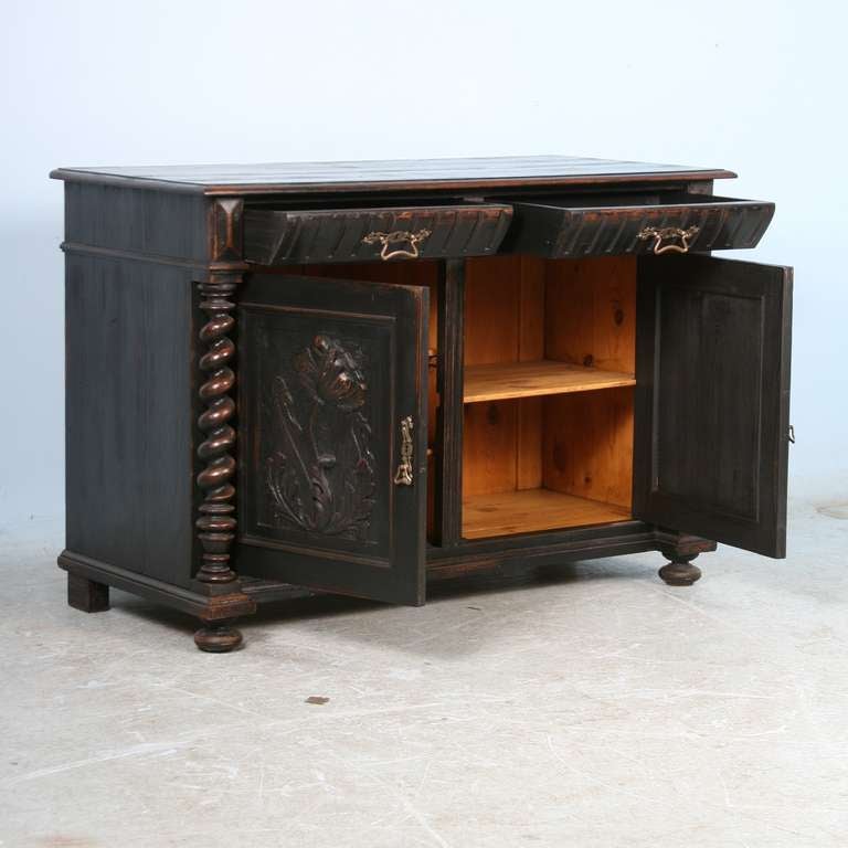 Lovely Danish sideboard from the late 1800's with carved panel doors and barley twist columns. Note the new black finish which has been perfectly distressed to reveal the rich wood color below creating a depth to the piece. This piece is clean,
