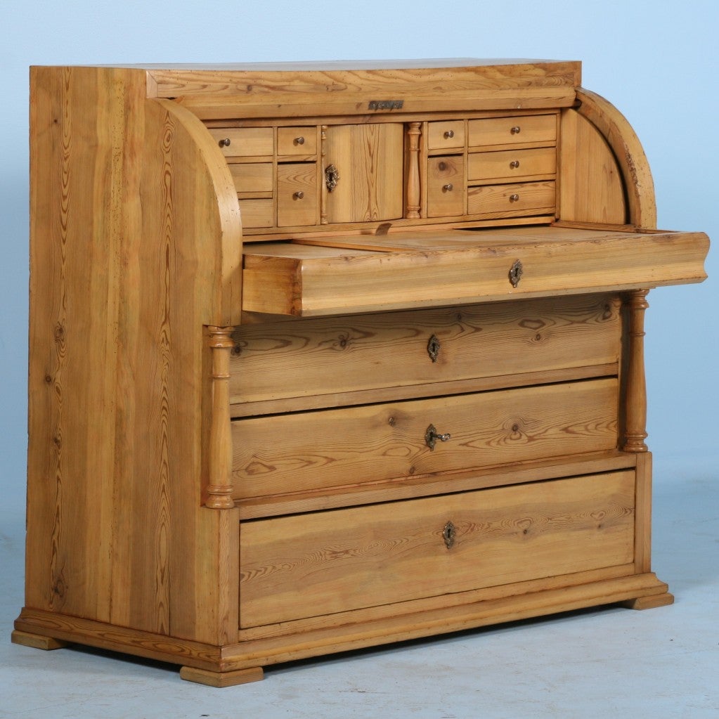Danish Pine Secretary. This Roll-top secretary hides 11 wonderful drawers within and 3 large storage drawers below the secretary surface. A fun aspect to the 