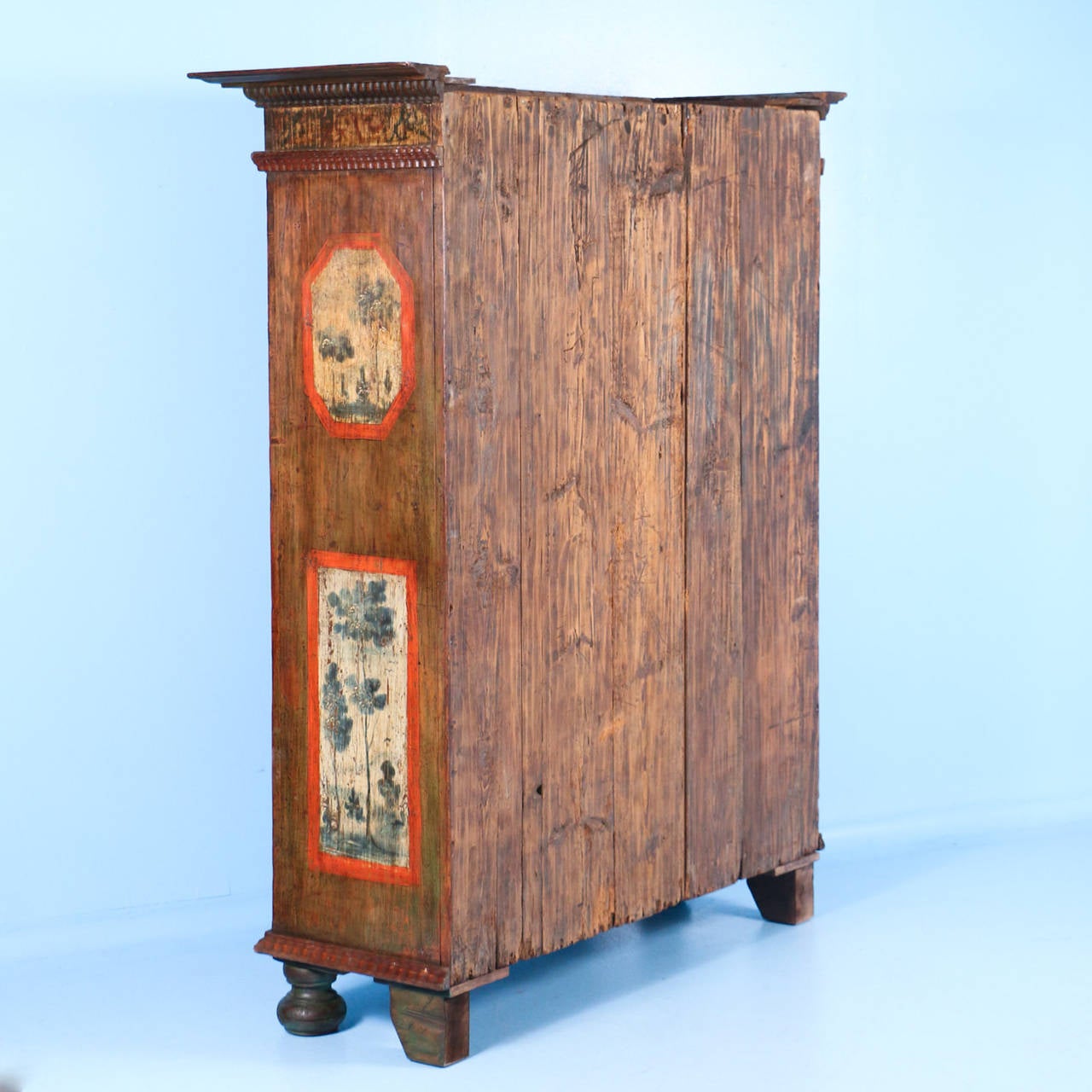 This large two-door armoire is dated, circa 1760s and still maintains its exclusive, Rustic patina in the paint. Although faded through the years, the paint is lovely. Please examine the close up photos to appreciate the Silhouette of trees in