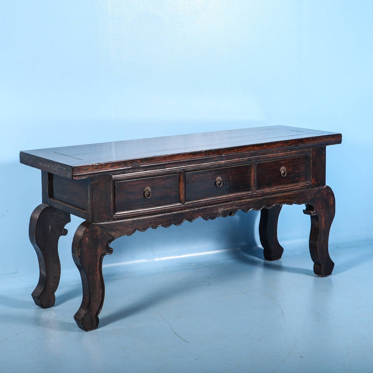 Chinese Console Table or Alter Table from Jiangsu Province of China. The dramatic curve of the legs and rich coloring of the wood are the elements that first strike one who sees this console in person. It has three wide opening drawers, hand carved