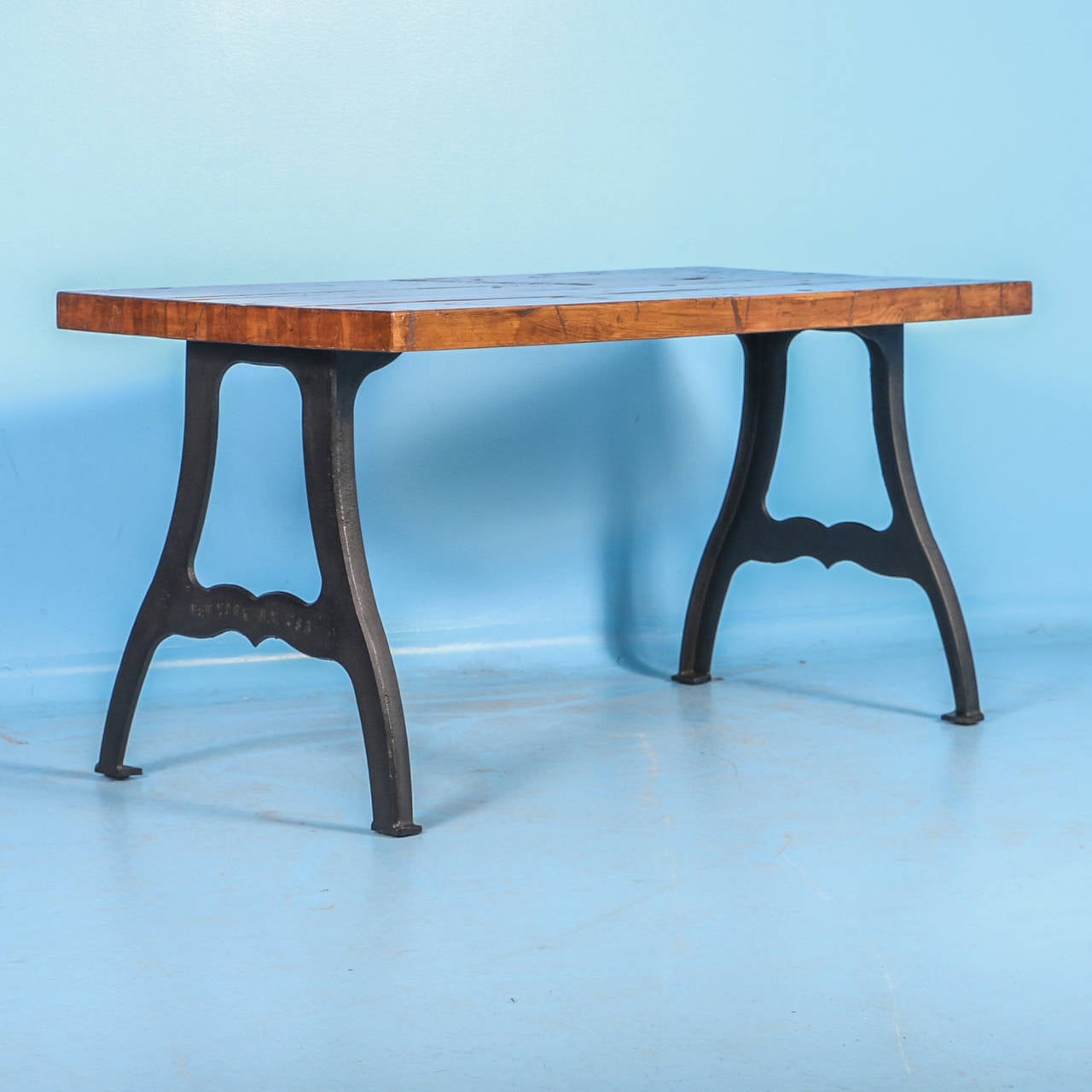 The strong visual appeal of this writing table table comes from top, made from  reclaimed railroad cart wood revealing countless years of use. The boxcars were used in the early 1900's in the US. The heavy cast iron base is a great contrast to the