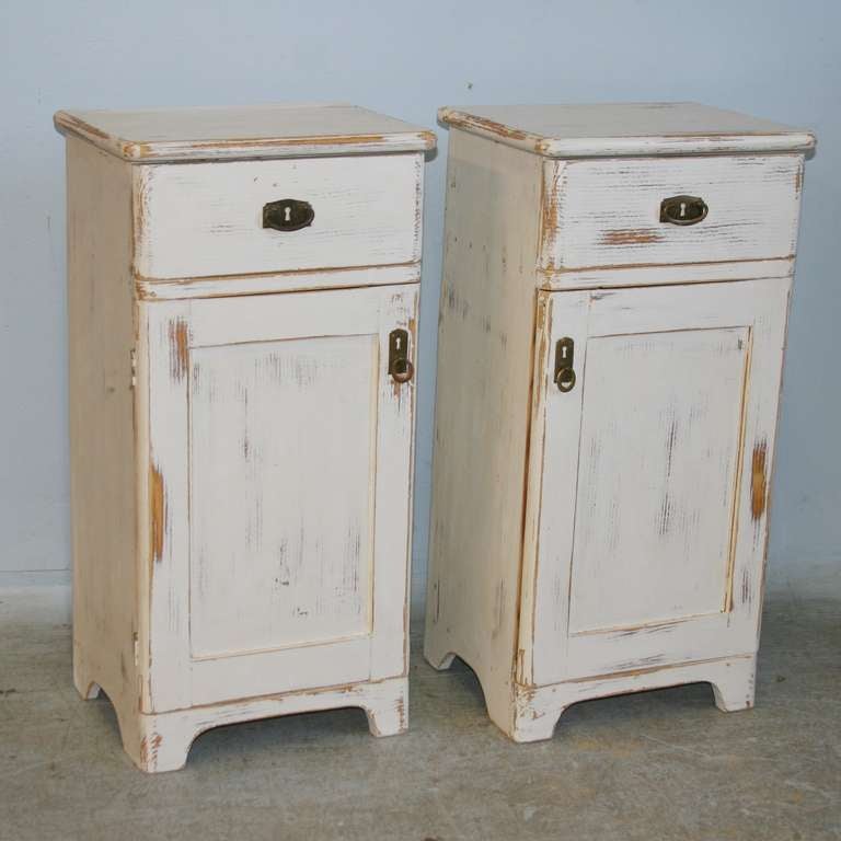 This pair of white nightstands are the perfect size to fit in a tight space. One door opens from the left, the other from the right to best acomodate ease of use. The white distressed paint finish is new, complimenting the simple country charm of