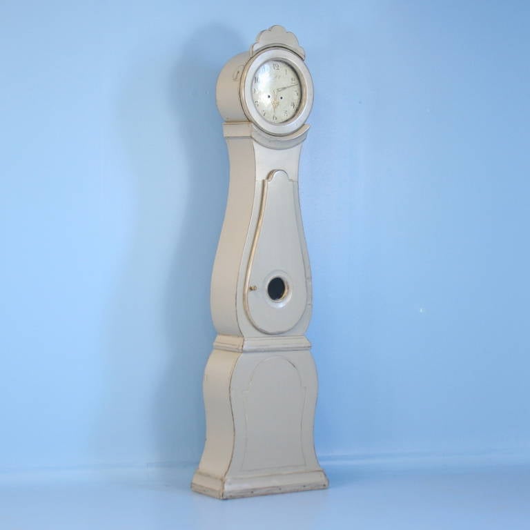 Gentle curves grace this Mora Grandfather Clock from the Mora region of Sweden. It has been given a soft, dove grey painted finish which adds to its romantic appeal. The original clockworks can be restored or we will have a battery function