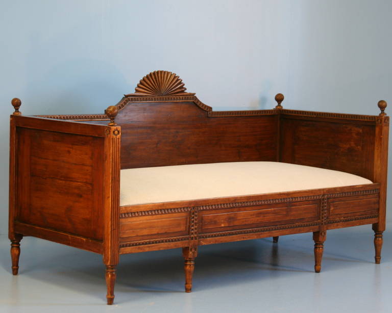 Beautiful carved details, turned finials and feet accentuate this dark pine daybed from Sweden made in the Gustavian period. The mattress is new and upholstered in linen, so it is ready to be placed and used.