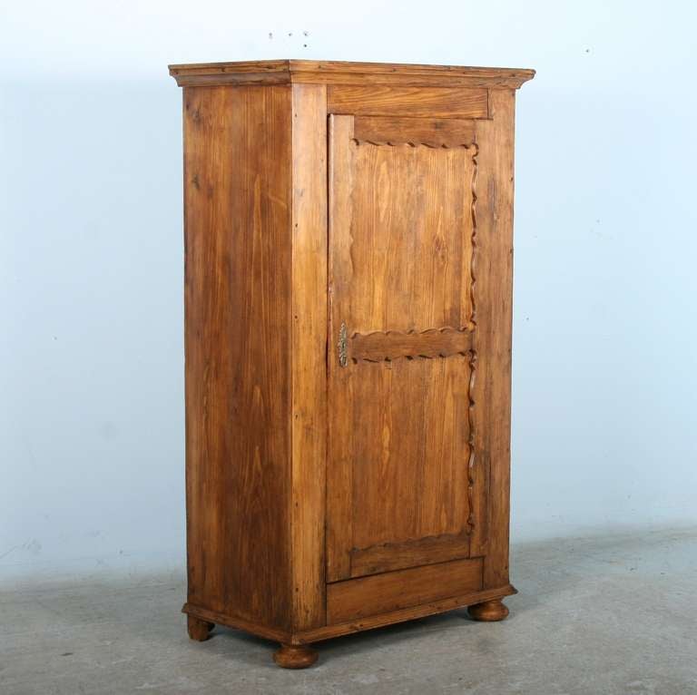 This one door pine armoire was a common household item throughout Europe in the 1800's in the days before built in cabinets and closets. Both charming and functional, it has been completely restored, waxed and is ready for use. Please inquire if you