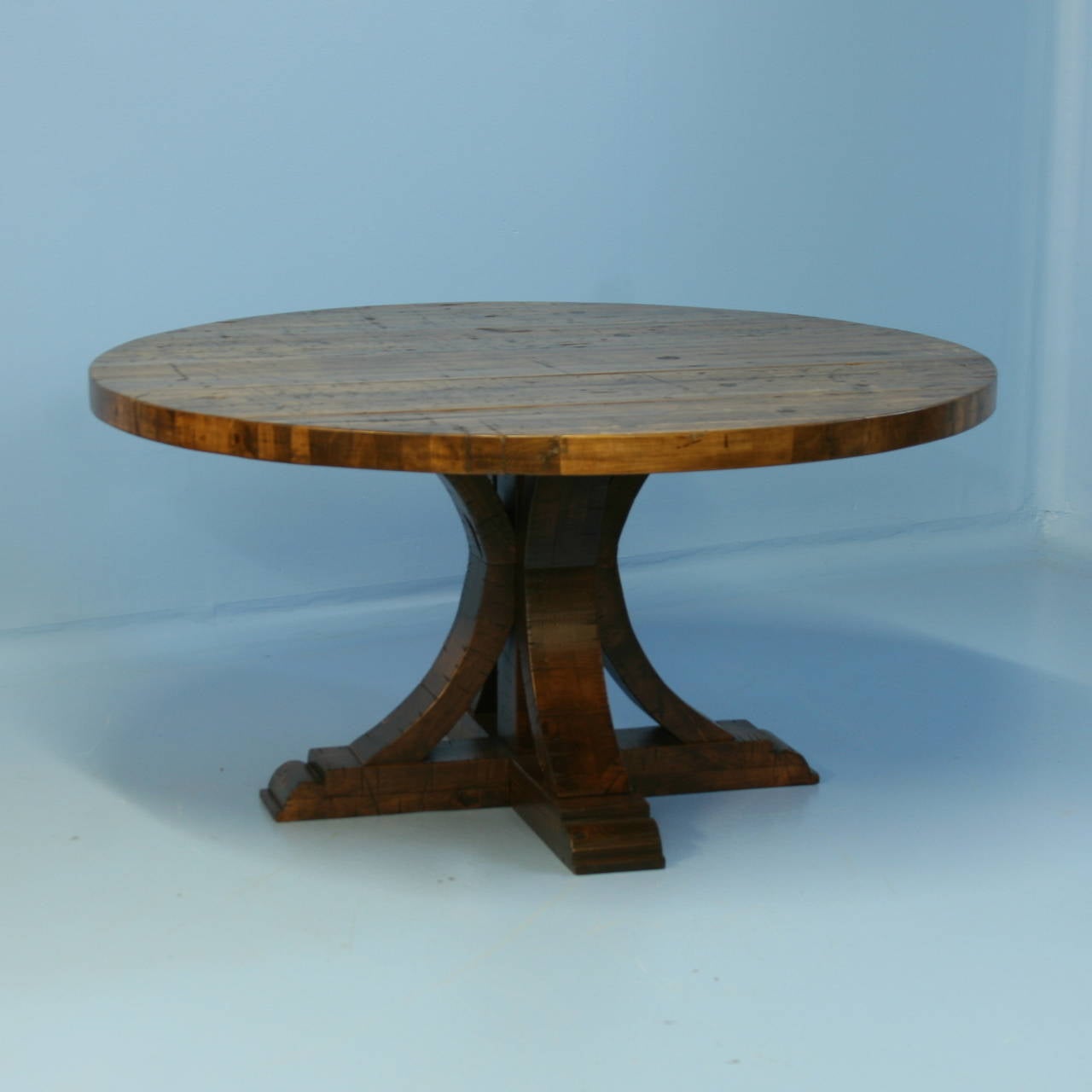 The strong visual impact of this table is due to the reclaimed wood top and architectural feel of the pedestal base. The top is made from reclaimed railroad cart/boxcar wood so it shows the wear and distress of constant years of use. The top is
