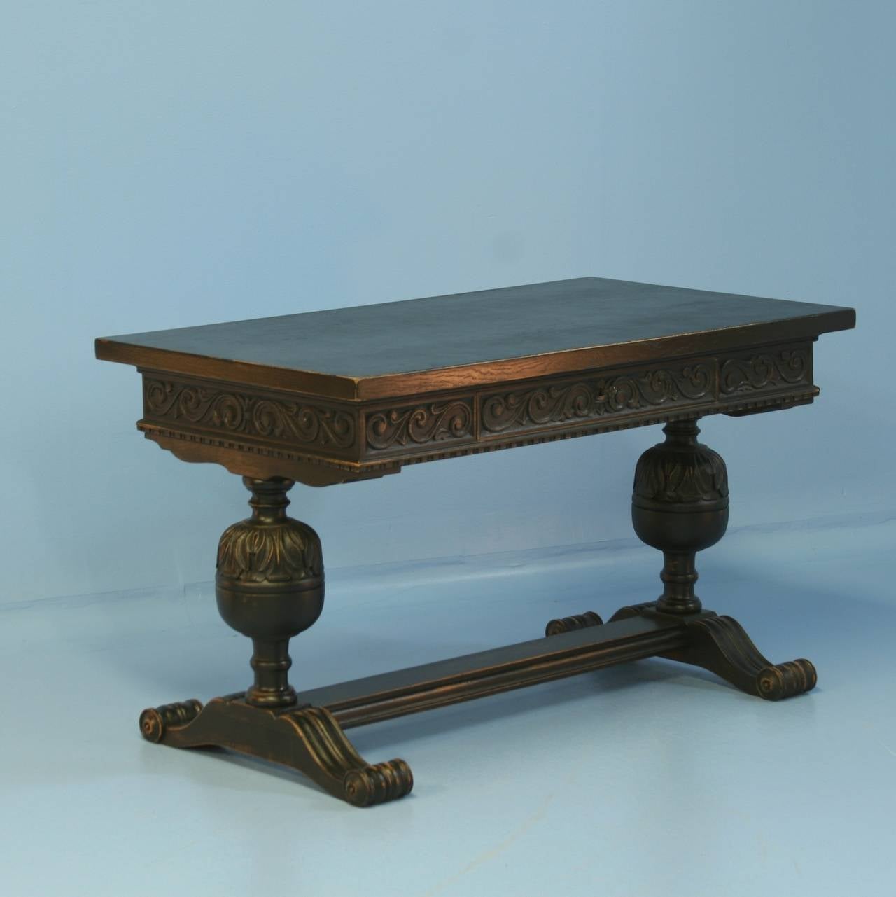 The intricate carving and tremendous turned legs with stretcher base create dramatic impact in this antique desk from Denmark. Please examine the carved details that encompass the 