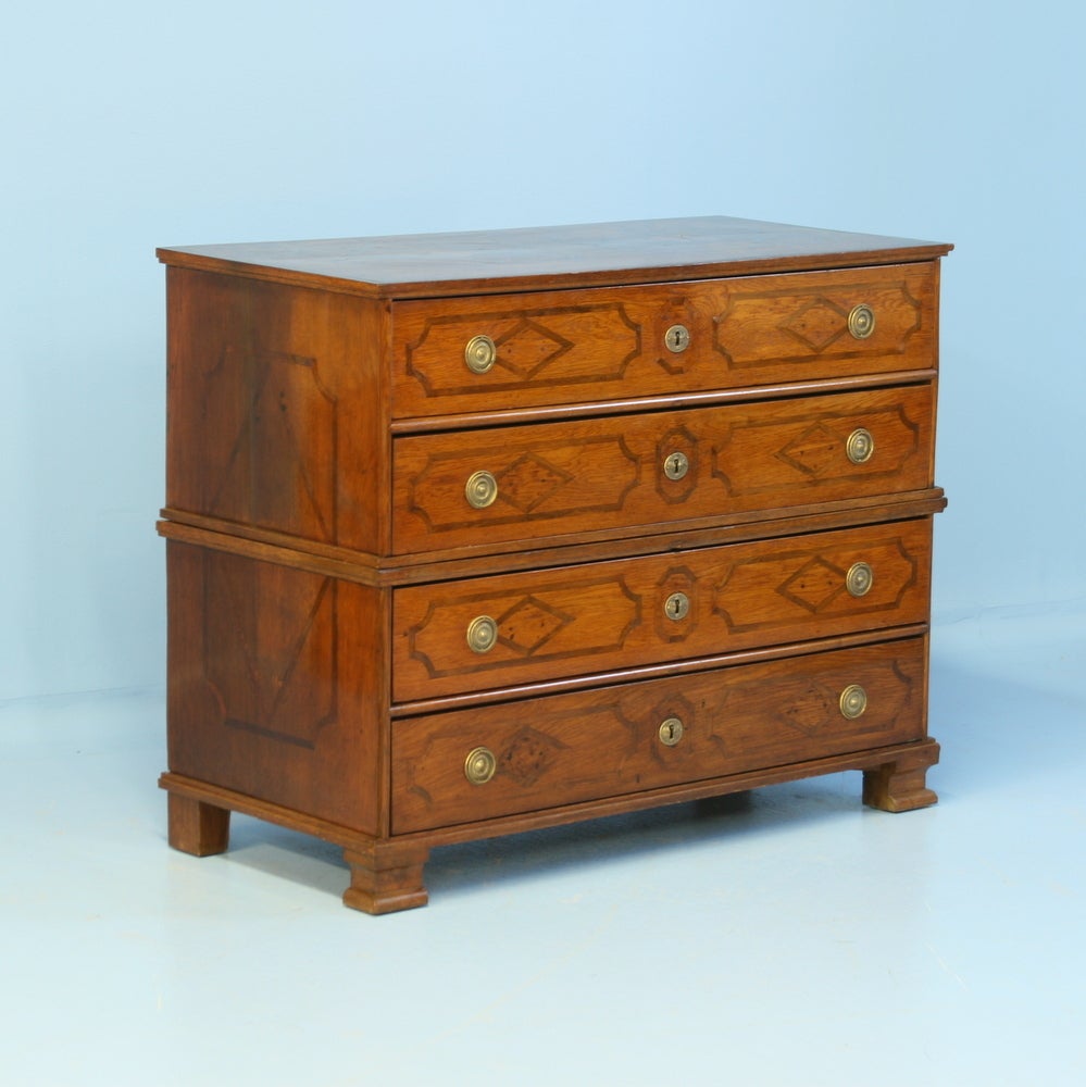 Beautiful inlay accents this lovely English baroque oak chest of drawers. Please review the many close up photos of the top, drawers and sides to appreciate the craftsmanship, as well as the lovely patina of the aged wood. The chest was built in 2