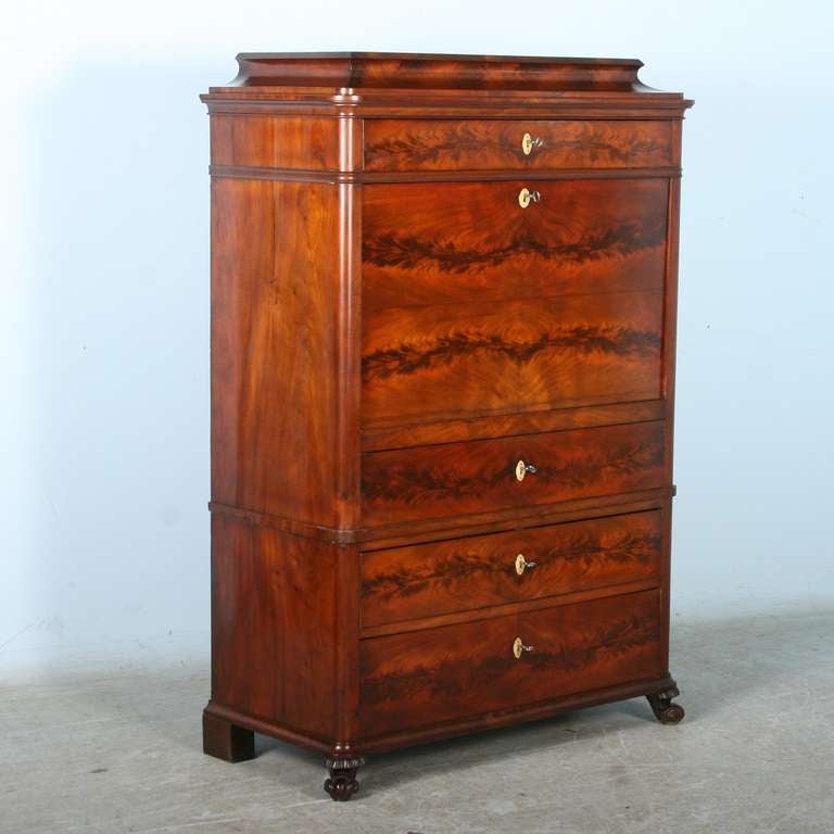 Stunning mahogany veneer is the hallmark of this striking secretary. Note the beautiful flame along each of the large exterior drawers, as well as the inlay of the petite interior drawers. When desk is opened, the depth is 35.5.