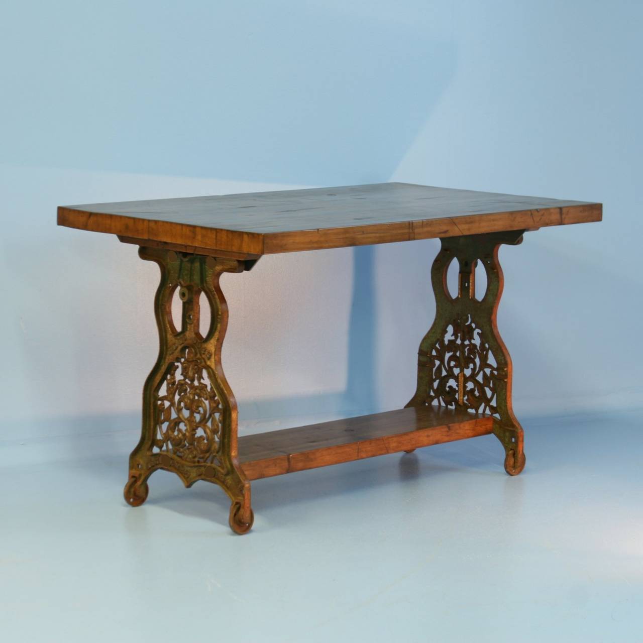 This incredible kitchen island is a one-of-a-kind find. The table top and foot rest are made from reclaimed railroad cart/boxcar wood from the 1920's. Note the rich patina and worn look of the heavy top. The iron base is also remarkable, made from