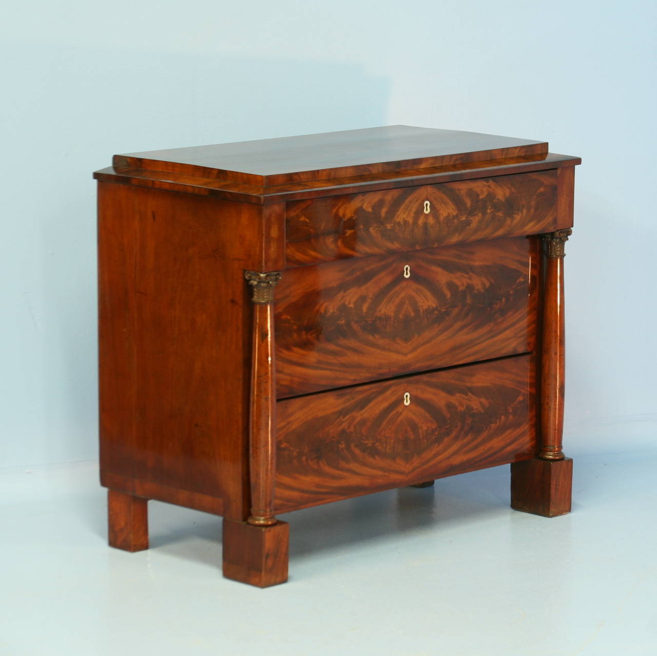 The  mahogany in this chest of drawers is striking. Please examine the close up photos to appreciate the deep color and beauty of the wood. The turned column details add a classic touch to the clean lines of this formal Biedermeier chest of drawers.