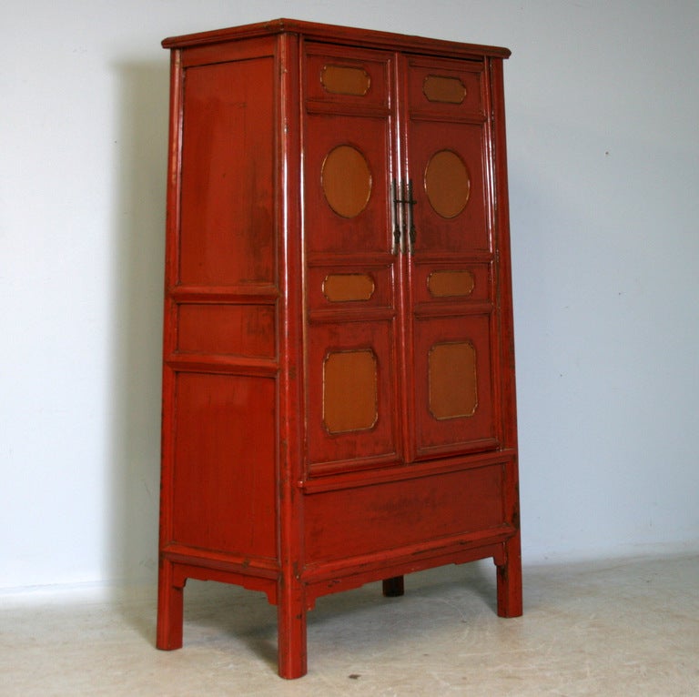 Antique Lacquered Chinese Cabinet With Original Paint. The unique shape and paneling on the cabinet doors creates the great visual impact of this piece. Please view the close up details to appreciate the true, original colors. The interior includes