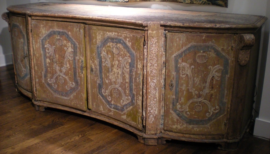 Incredible 17th century painted (original paint) Italian credenza with marbleized drawers concealed behind the four doors of the serpentine shaped facade. Hardware is original. 