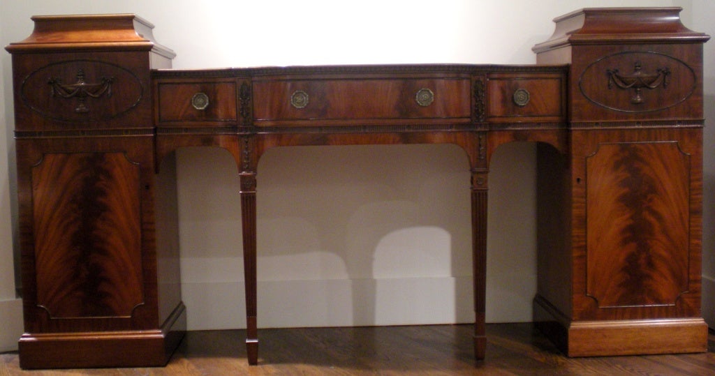 Exceptional sideboard incorporating pedestal ends concealing metal lined liquor drawer. Imposing size, but still retaining a delicate scale. All hand-carved by London cabinet maker.