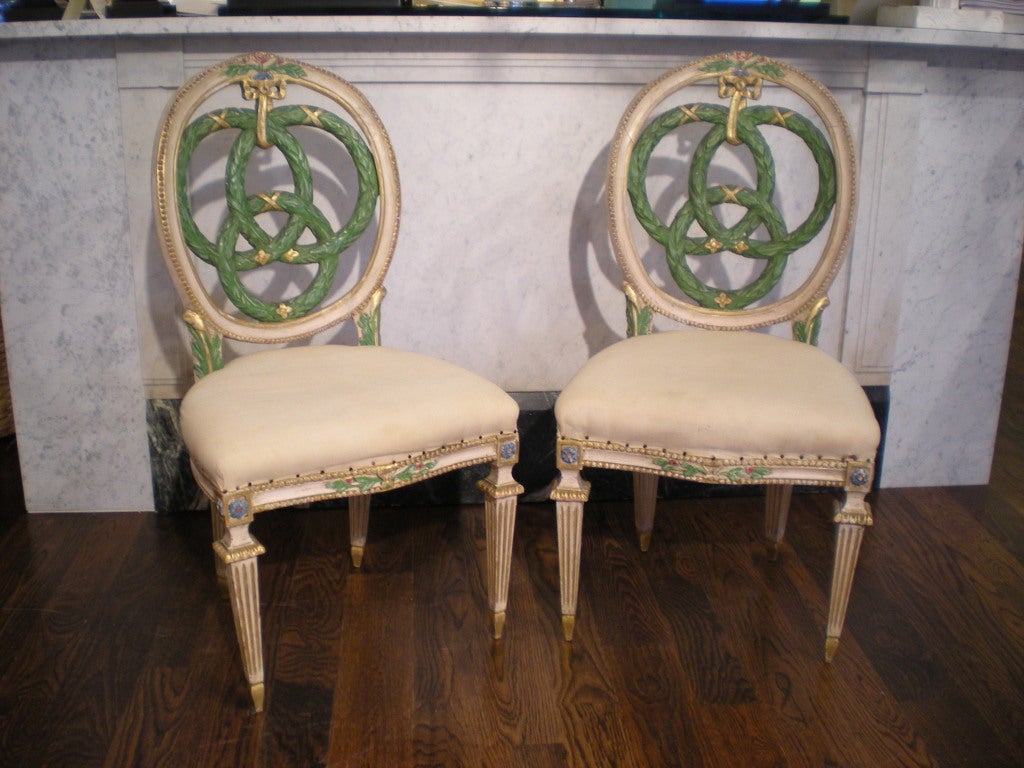 Painted decoration; three intertwined laurel wreaths, ribbon tied; copies of 18th century chairs from same Roman palazzo. Selling as a set of ten.