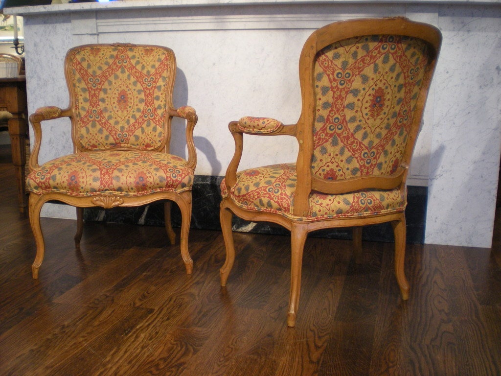 Pair of French beechwood chairs upholstered with paisley linen.