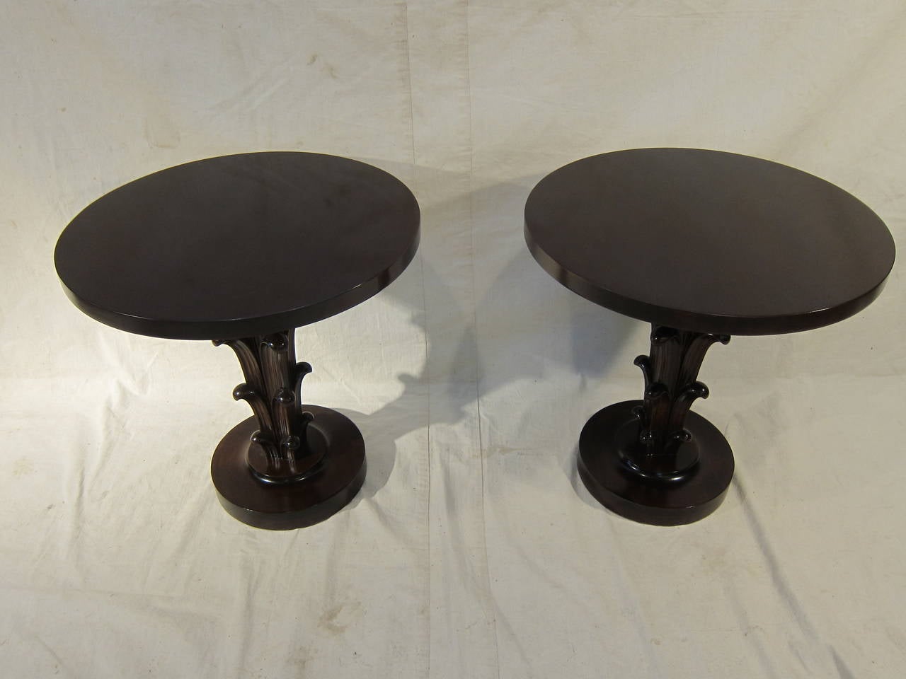 A pair of mahogany acanthus style pedestal tables made by Widdicomb attributed design T. H. Robsjohn-Gibbings, sold through John Stuart. Condition is excellent. Being sold as a pair only, circa 1950.