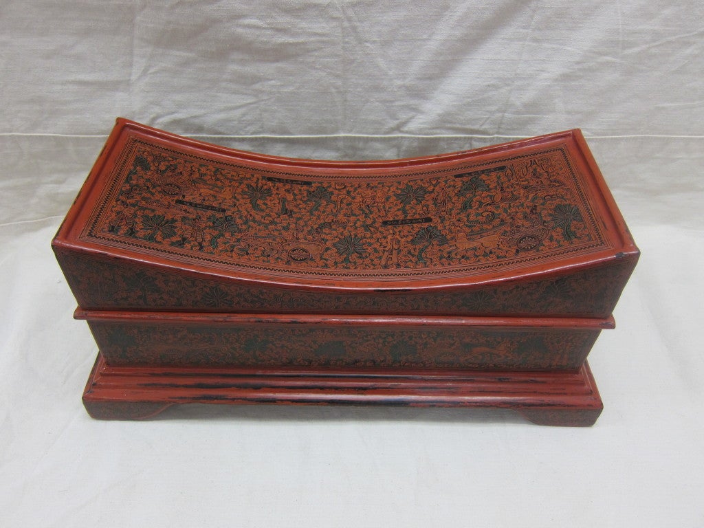Early 20th century Burmese lacquerware manuscript box. A concave toped box also referred to as a pillow box. Elaborately decorated by etching through the different colored layers of lacquer. This box is completely illustrated with art work, top,