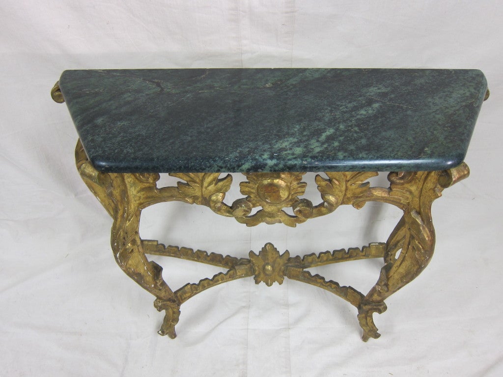 A Baroque carved gilded, 19th century console table in the style of Louis XV. Very good size for tight space, small foyer, hallway, entrance or living room. In good condition.