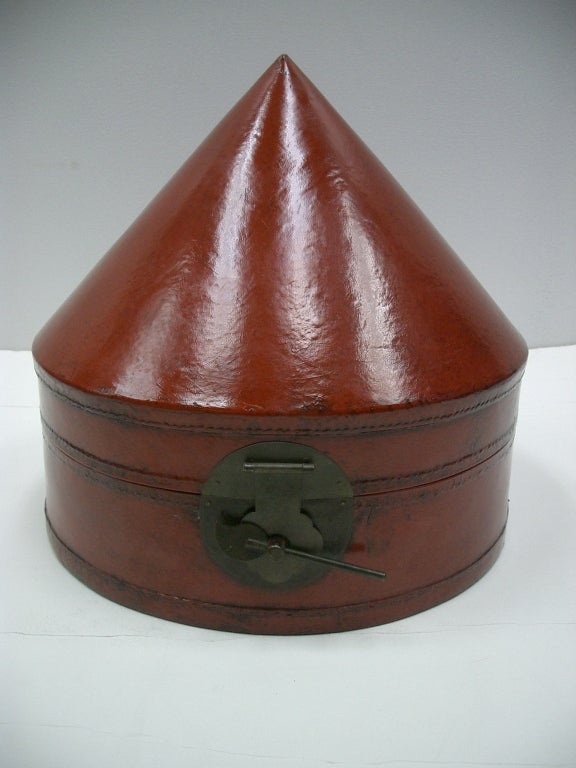Antique Chinese cone toped hat box, leather over wood, with red lacquer.