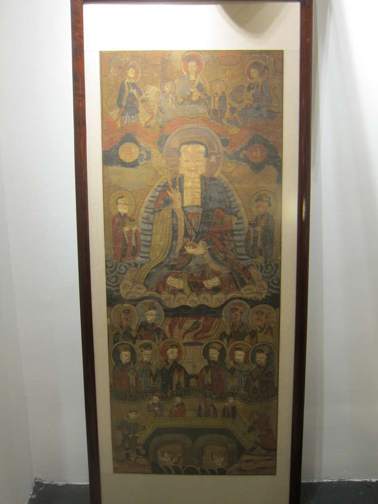 18th  century Buddhist Chinese Scroll Painting. 
This is a temple piece and has been re-backed numerous times over its life span.  The practice of re-backing these types of scrolls paintings was common as part of continuing the use and life of the