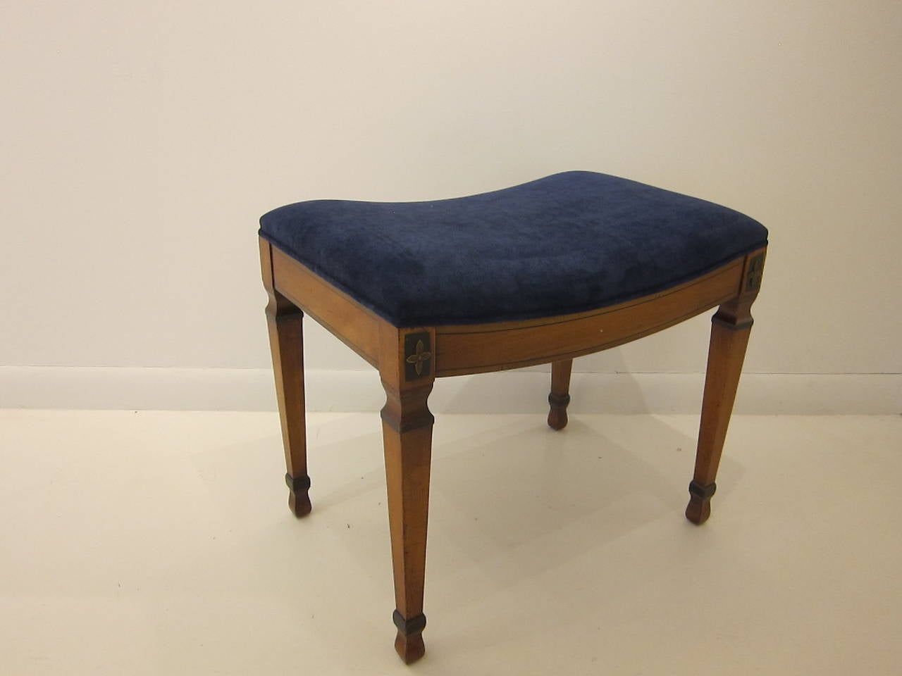 Early 20th century Biedermeier stool. Pear wood with new velvet covering in very good condition.  Tapered legs with carved floret top detail and hour glass feet.   New covering in indigo velvet.  Perfect for sitting, comfortable. 
