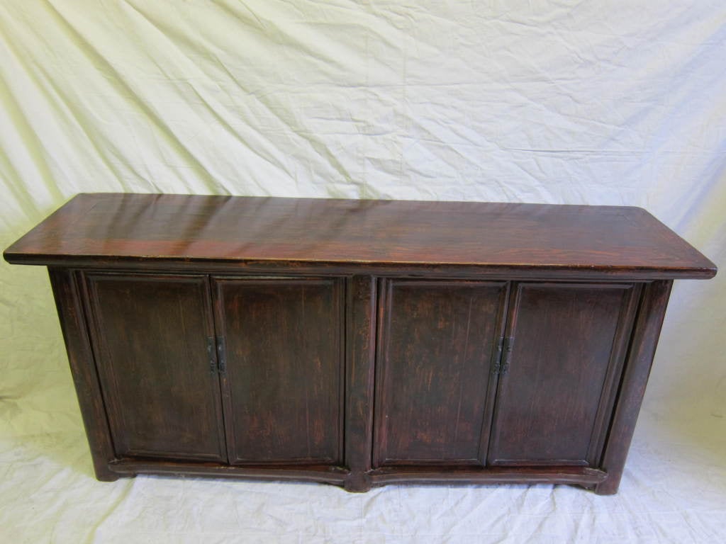 19th Century Chinese Elmwood Sideboard, four drawers inside with four shelf's.  Excellent server with lots of storage.  Color has Merlot - Burgundy tones through the brown.  CA 1850
Very good condition,  structurally strong and solid for every day