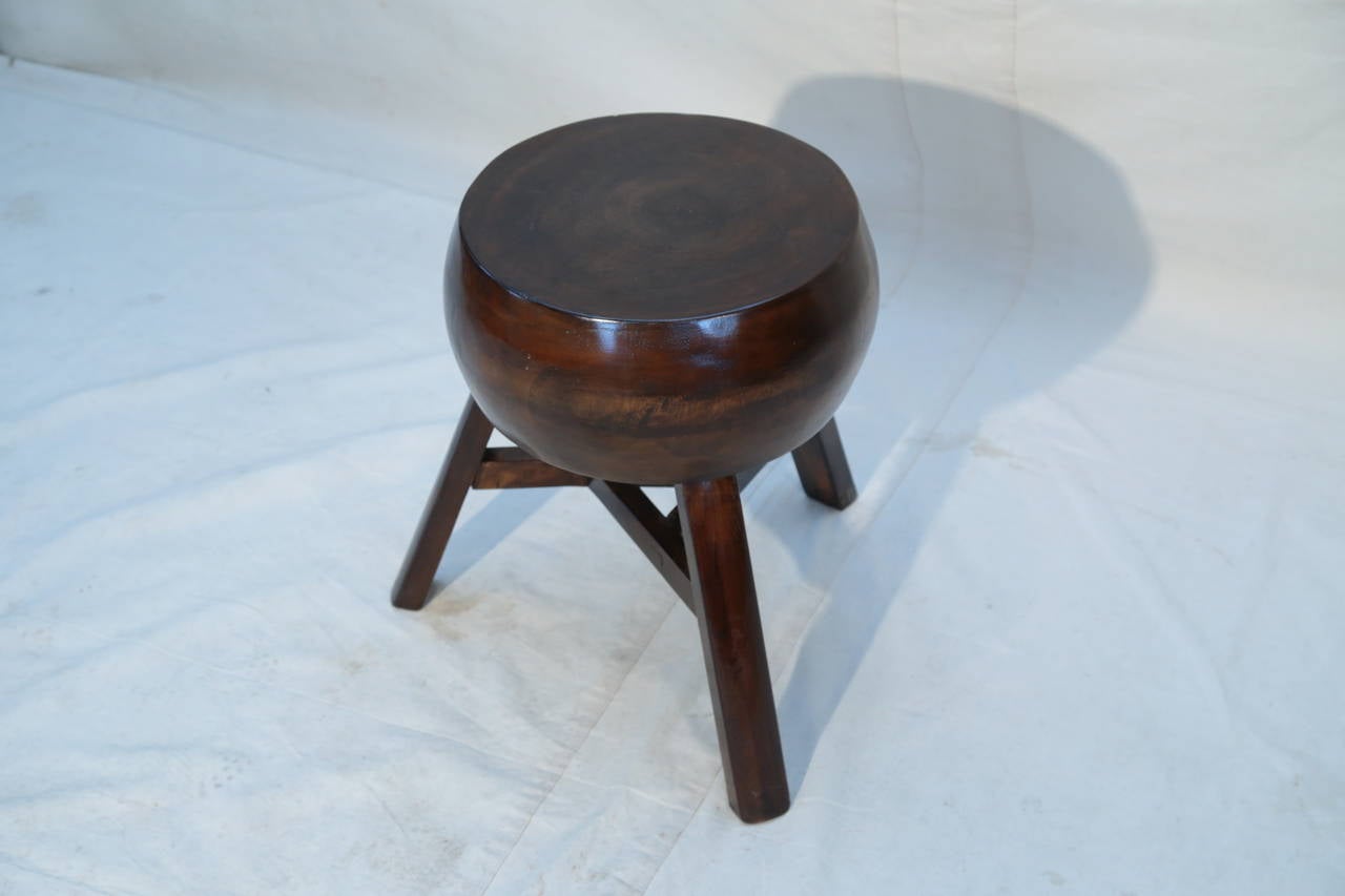 A cog adapted table and stool, 20th century.