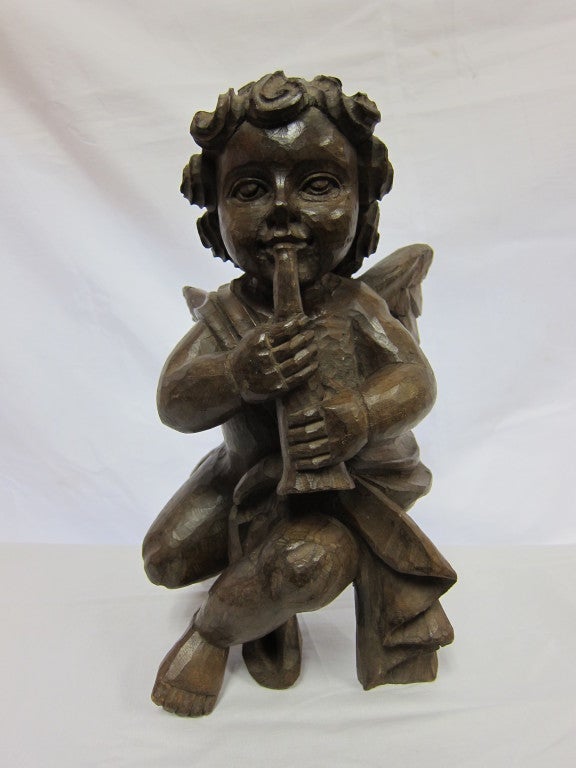 Wonderful 19th century Putto wood sculpture baroque carving of an Angel Cherub with instrument.  A solid carving from one piece of wood. Stands very sturdy on its own. Philippines, circa 1850.