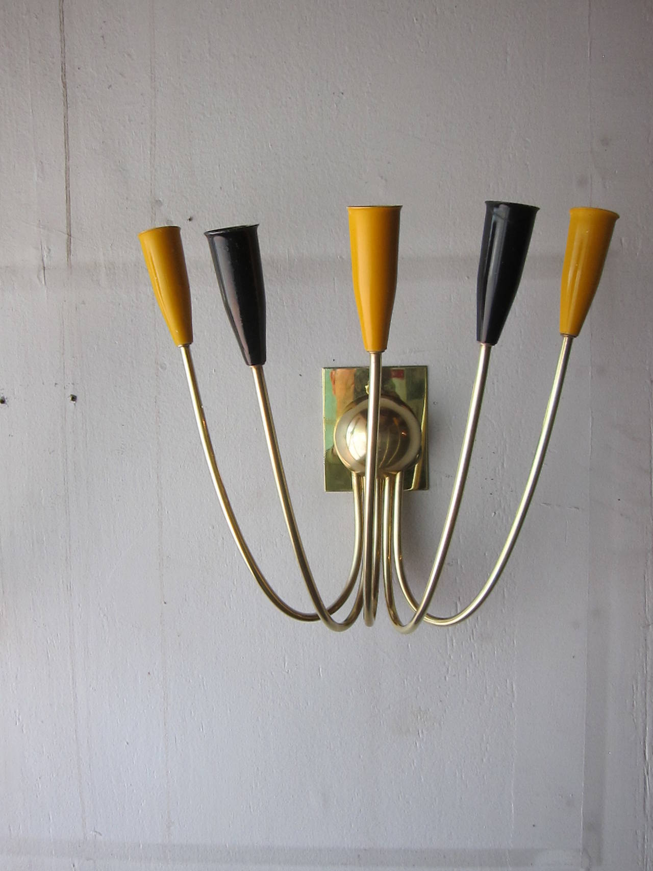 A pair of Stilnovo five-arm brass sconces. Very good condition, newly rewired. 
The sconces can be used with our without the rectangular brass wall plates. Please see the pictures. Italy, circa 1960.