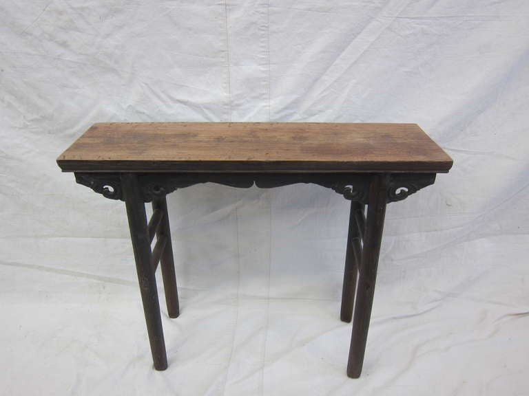 A early 19th century Altar table with carved apron, spandrels, and round legs having a solid one piece top. Wonderful patina small sized console table.  Small tables like these where often used as small altars for ancestor remembrance.  This